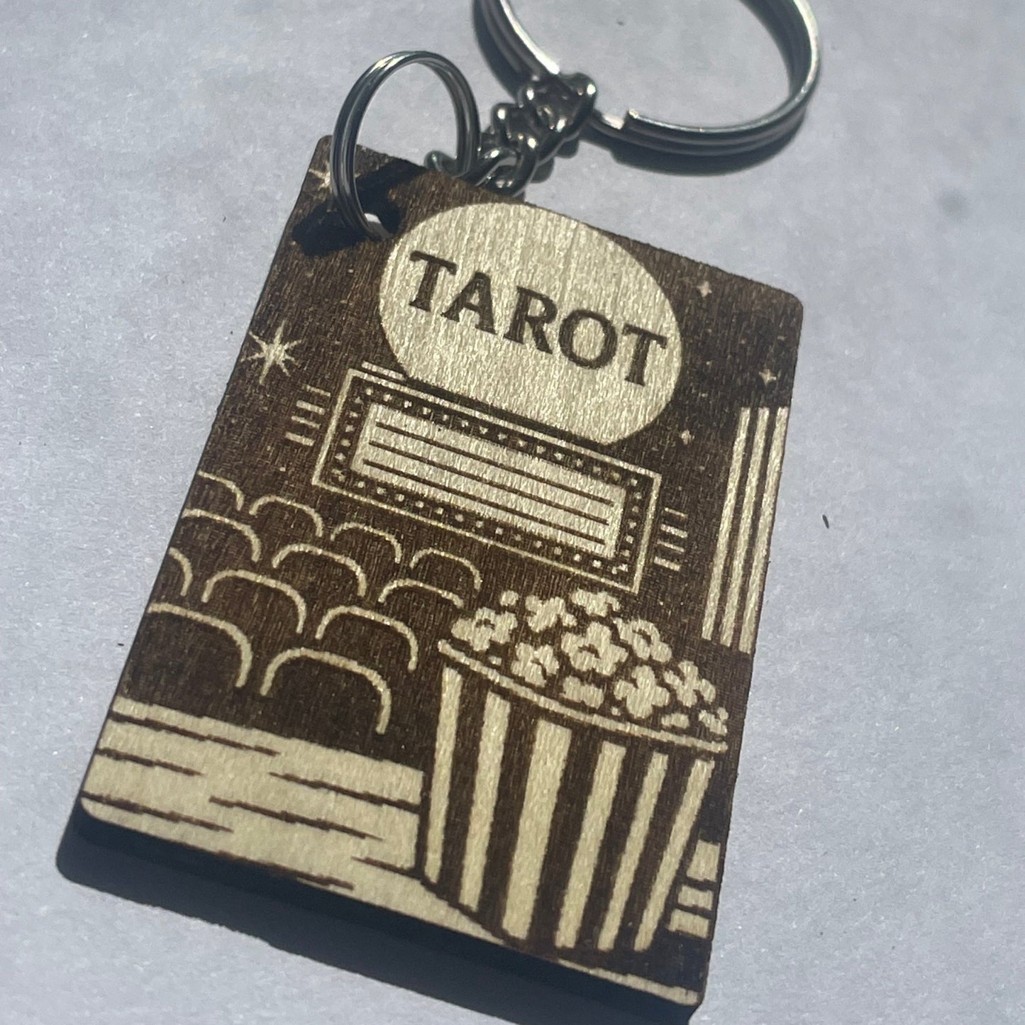 Keychain with tarot card design on a gray background
