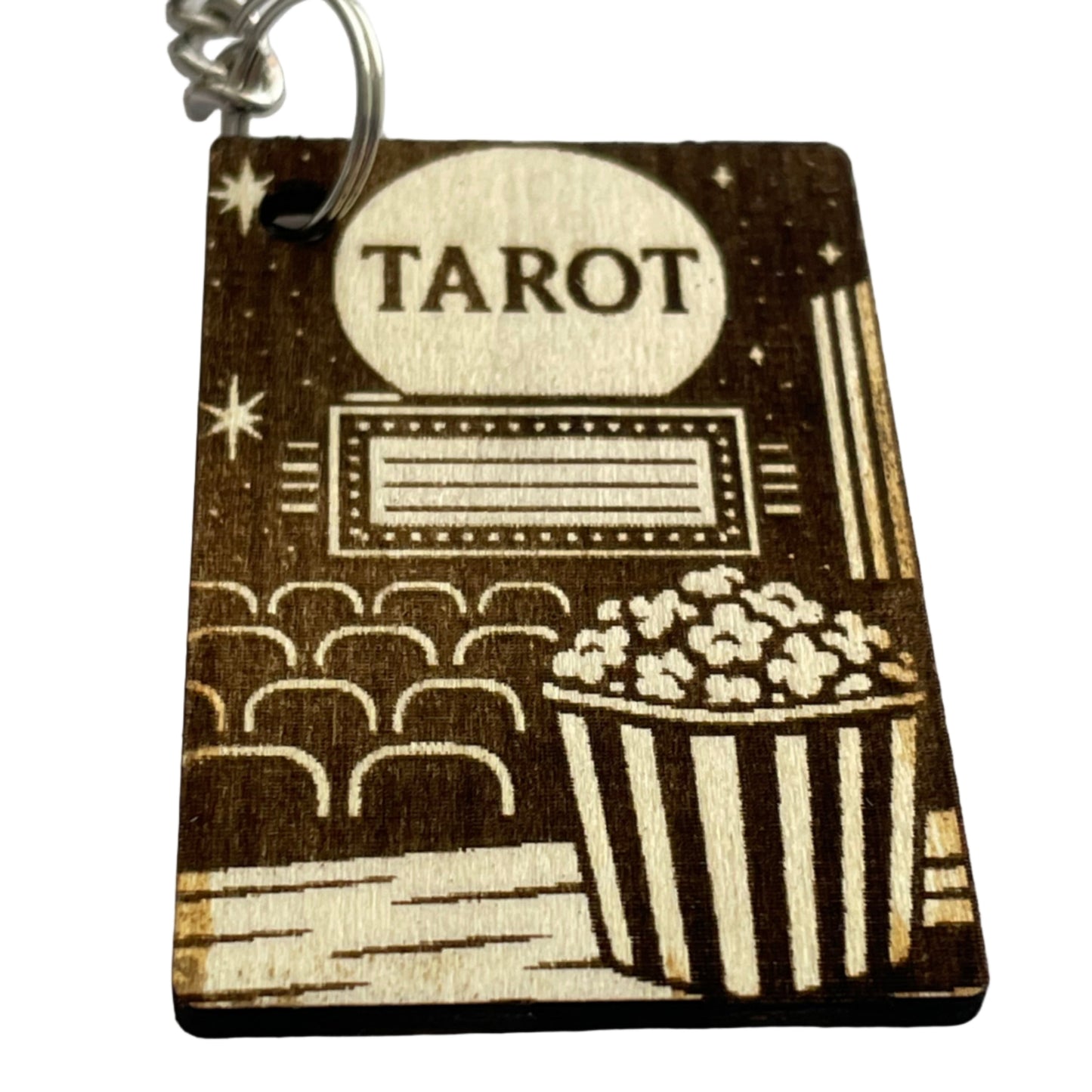 Wooden keychain with tarot card design and popcorn illustration on a light gray background