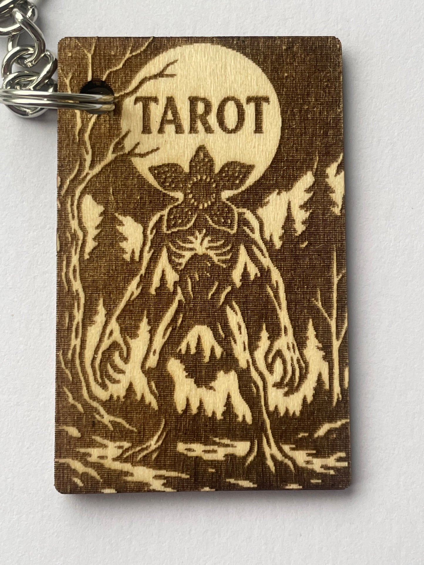 Brown tarot card with tree design and 'Tarot' text on a white background