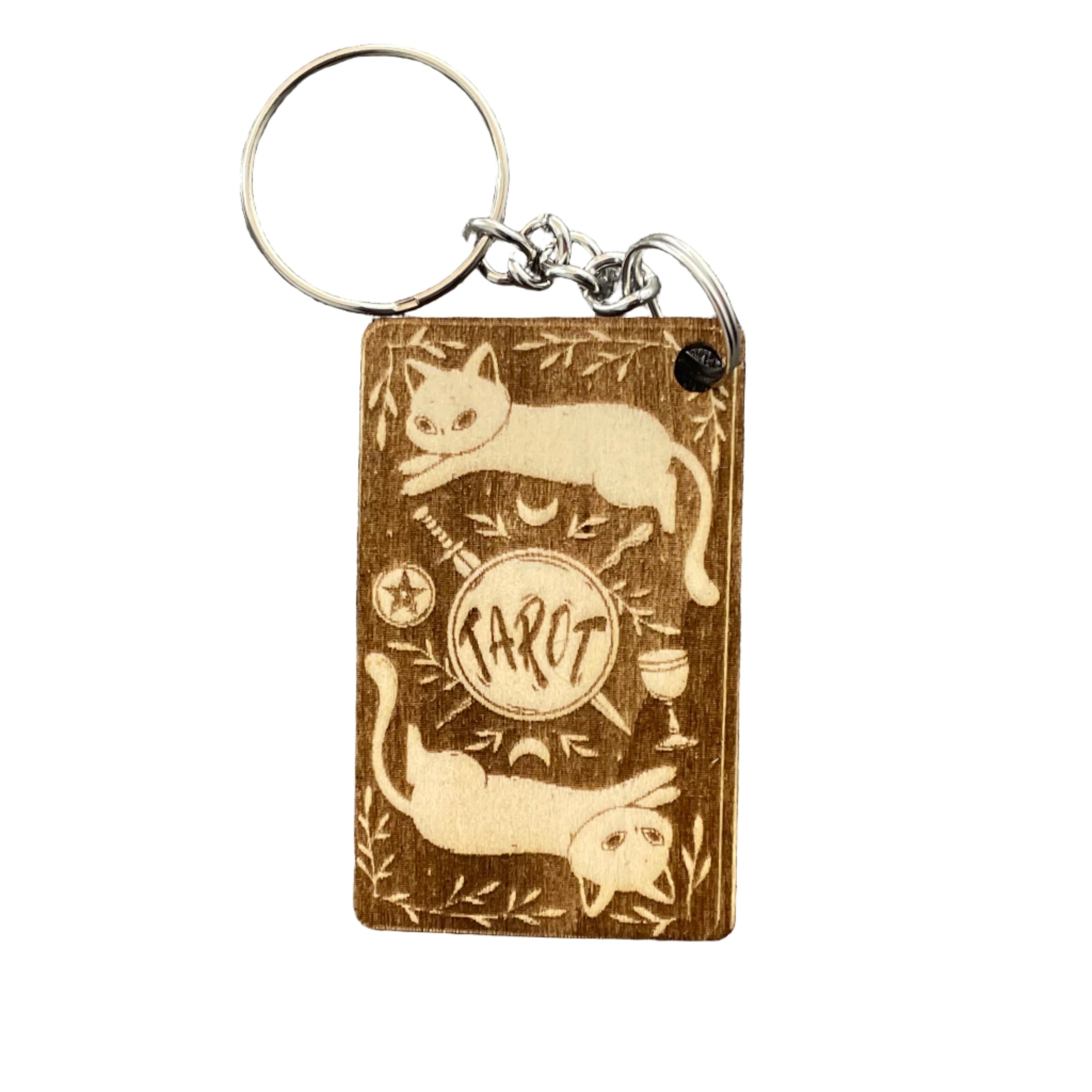 Wooden keychain with engraved design on a gray fabric background