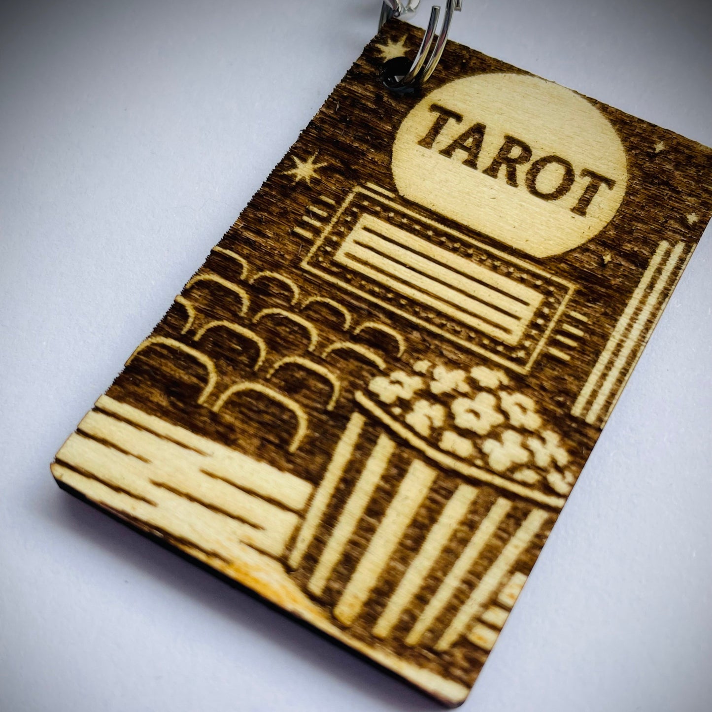 Wooden keychain with 'Tarot' engraving on a white background