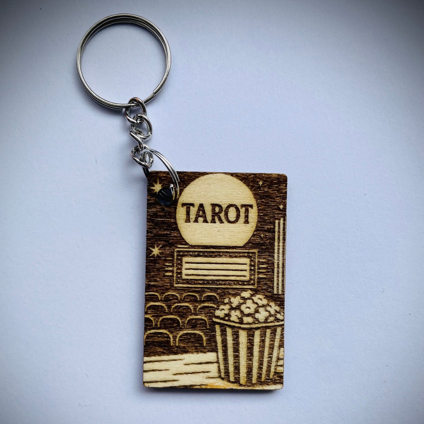Keychain with tarot card design on a gray background