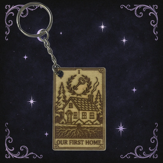 Keychain with house illustration and 'Our First Home' text on a decorative background