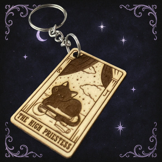Keychain with 'The High Priestess' tarot card design on a dark background