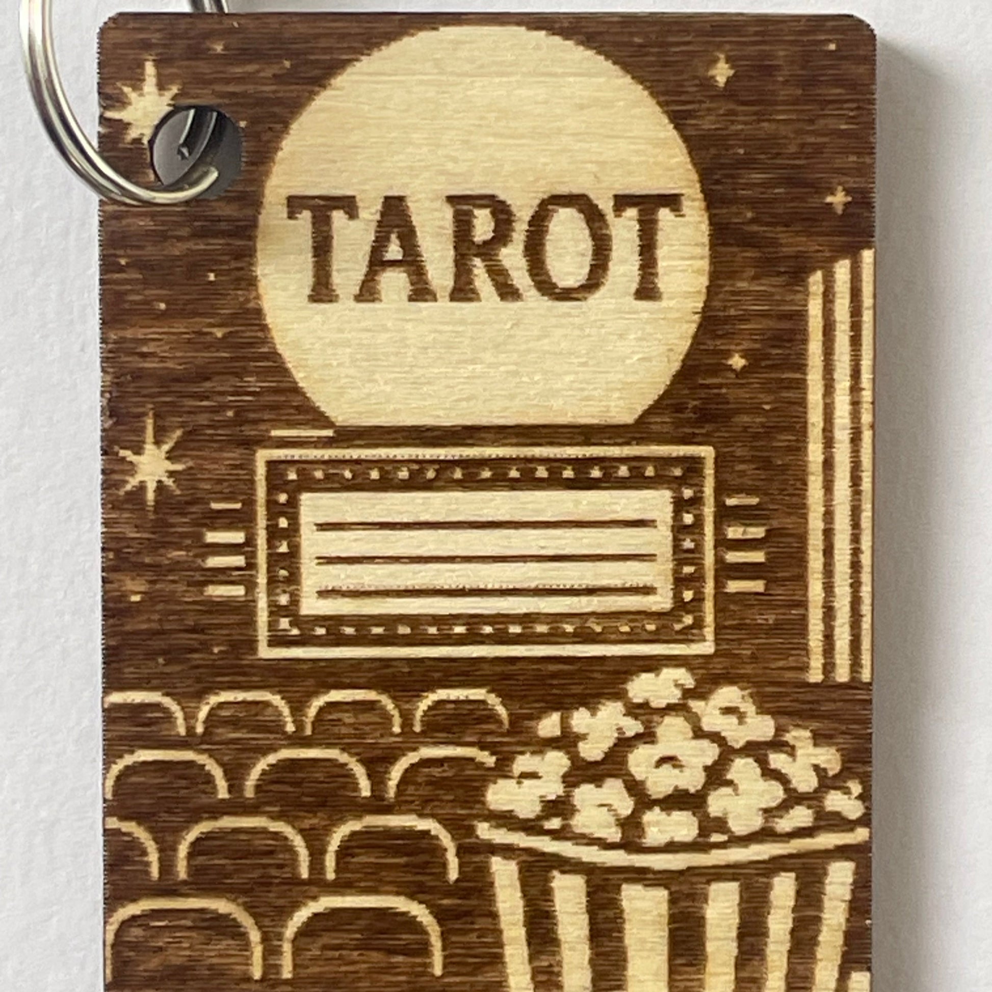 Wooden tarot card keychain with 'Tarot' engraving on a white background
