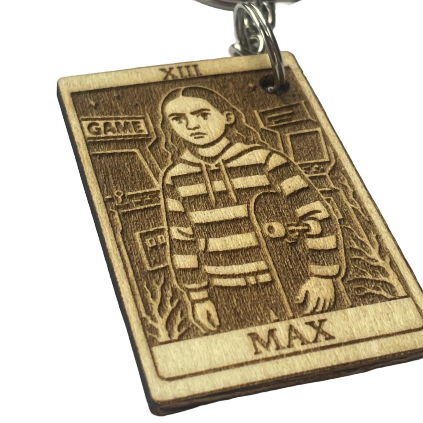 Bronze keychain with engraved design on a gray background