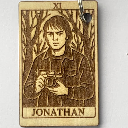 Wooden keychain with engraved design and 'Jonathan' text on a white background