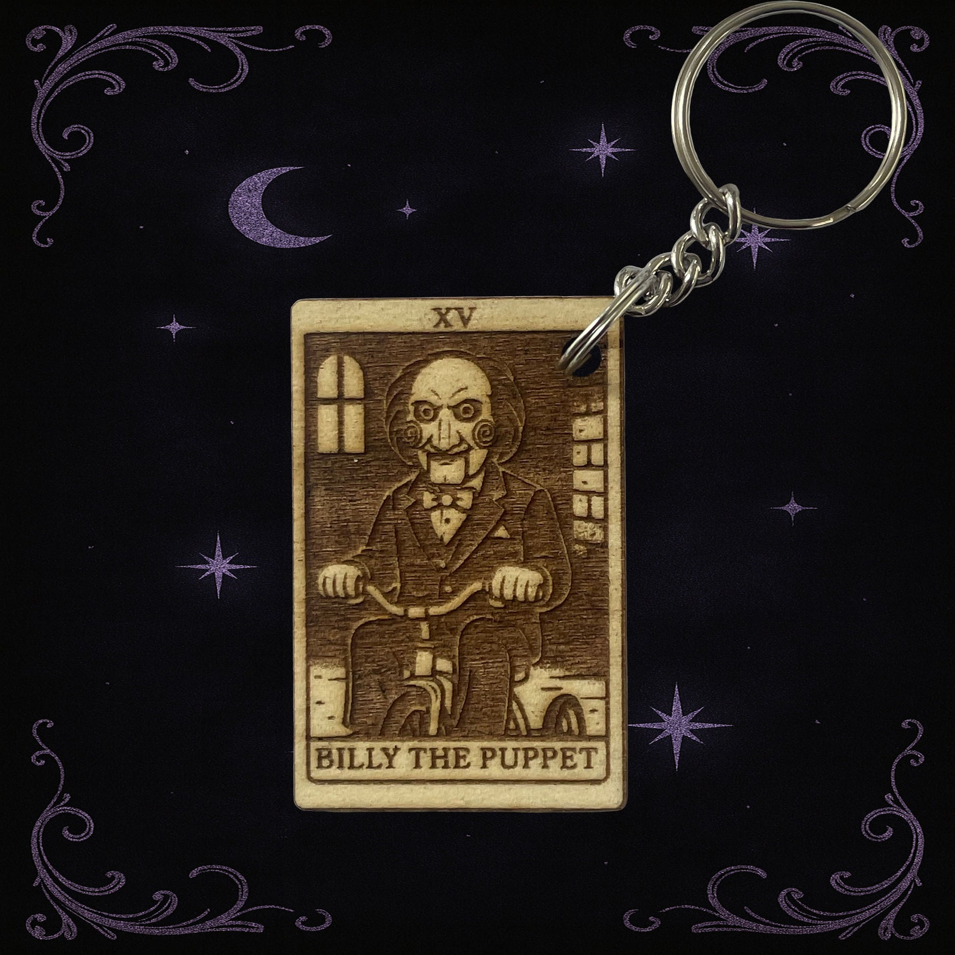 Keychain with 'Billy the Puppet' design on a dark background with stars and moon.
