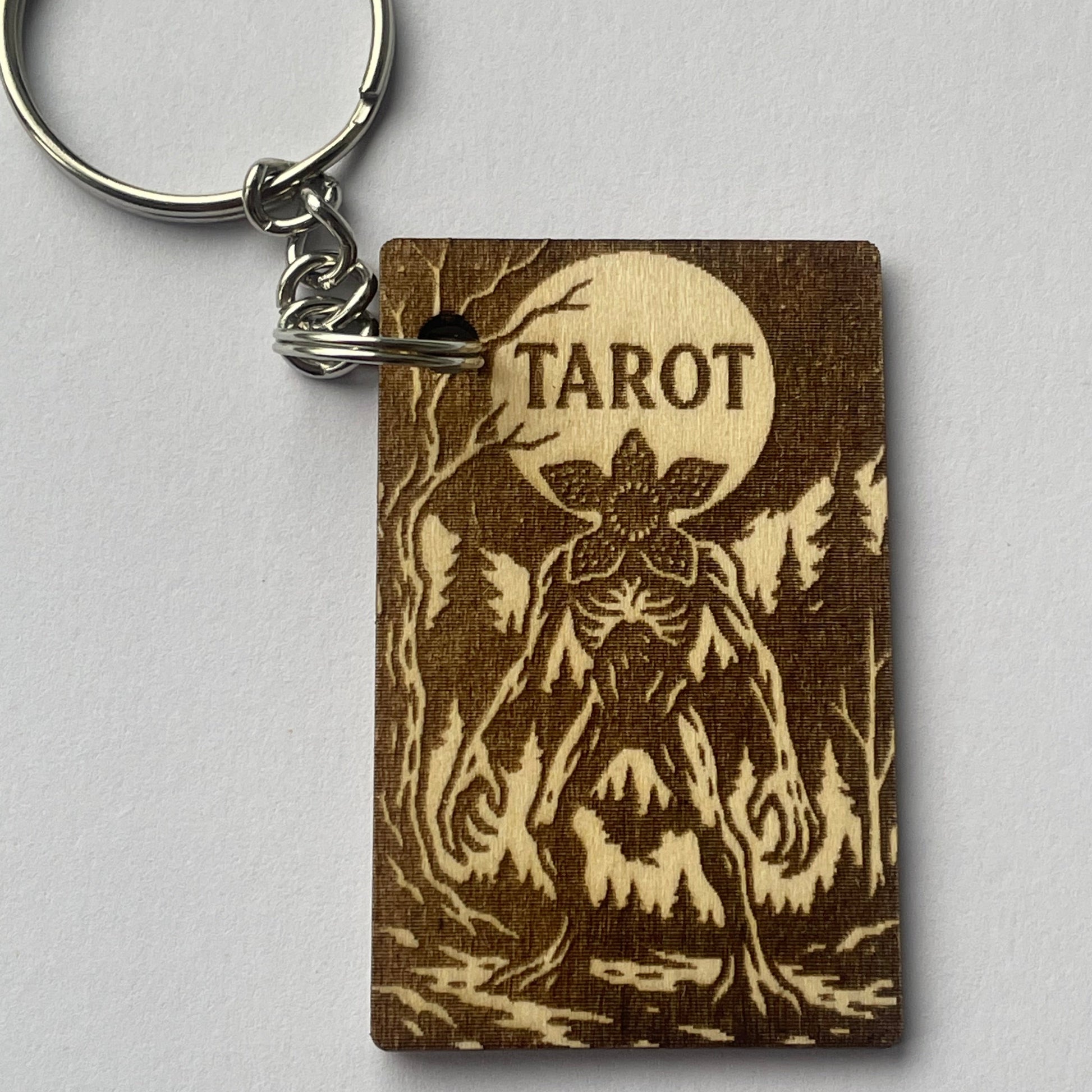 Keychain with tarot design on a gray background