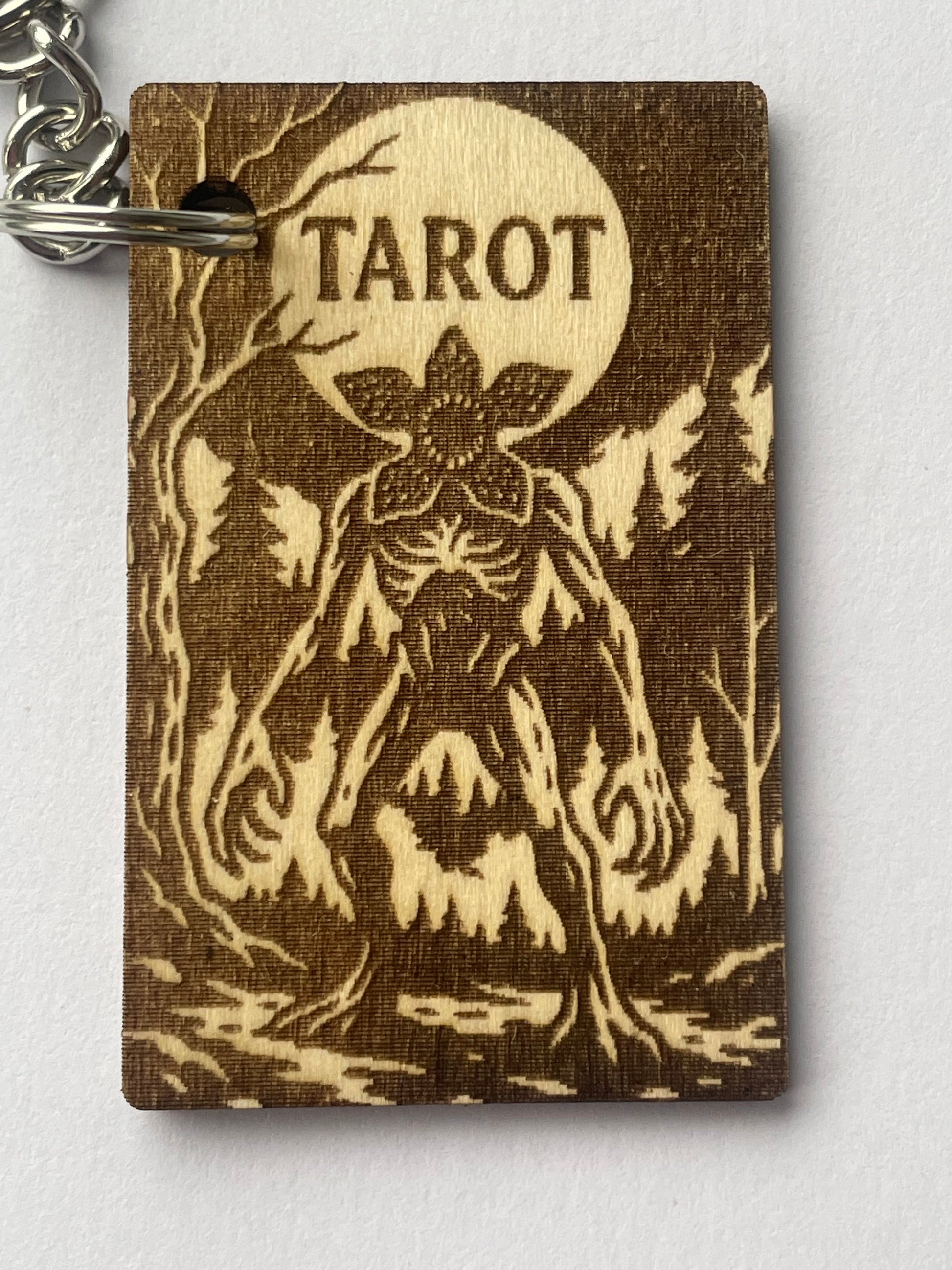 Brown tarot card with tree design and 'Tarot' text on a white background