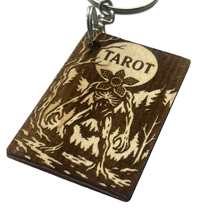 Wooden keychain with 'Tarot' engraving on a gray background