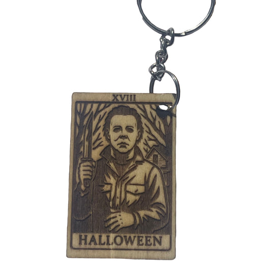 Wooden keychain with 'Halloween' design featuring a character holding an axe on a textured brown background.