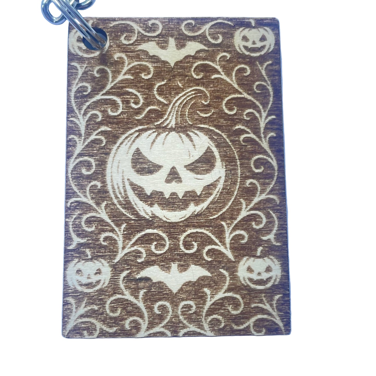 Keychain with Halloween design featuring pumpkins and bats on a blue background