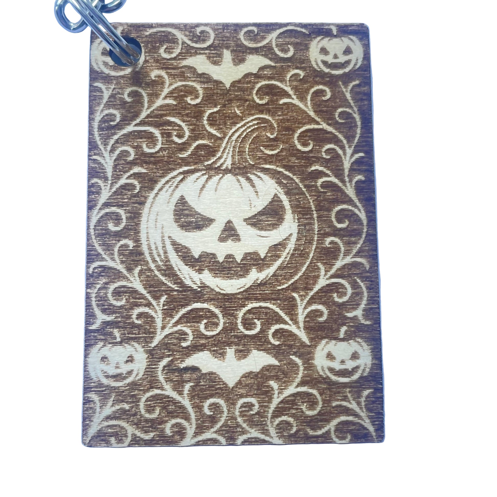 Keychain with Halloween design featuring pumpkins and bats on a blue background
