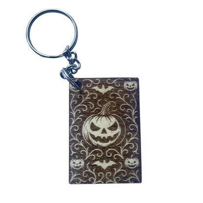 Keychain with Halloween design featuring pumpkins and bats on a purple background