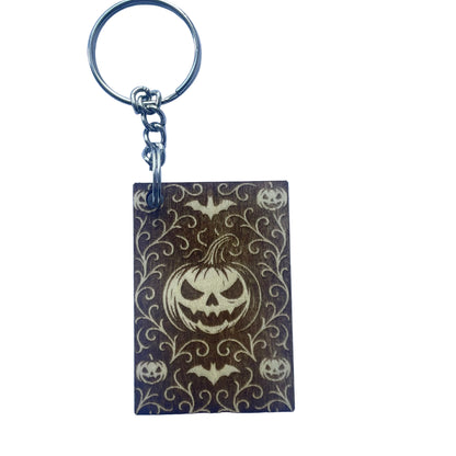 Keychain with Halloween design featuring pumpkins and bats on a purple background