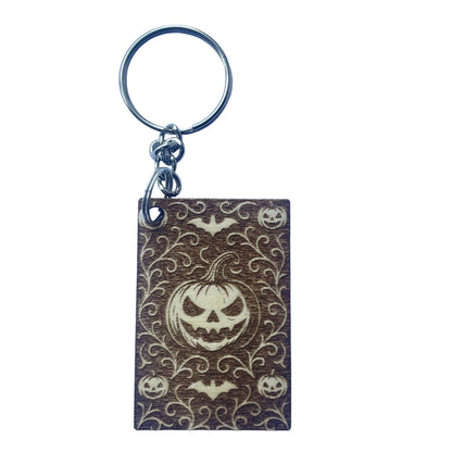 Keychain with Halloween design featuring a pumpkin face on a white background