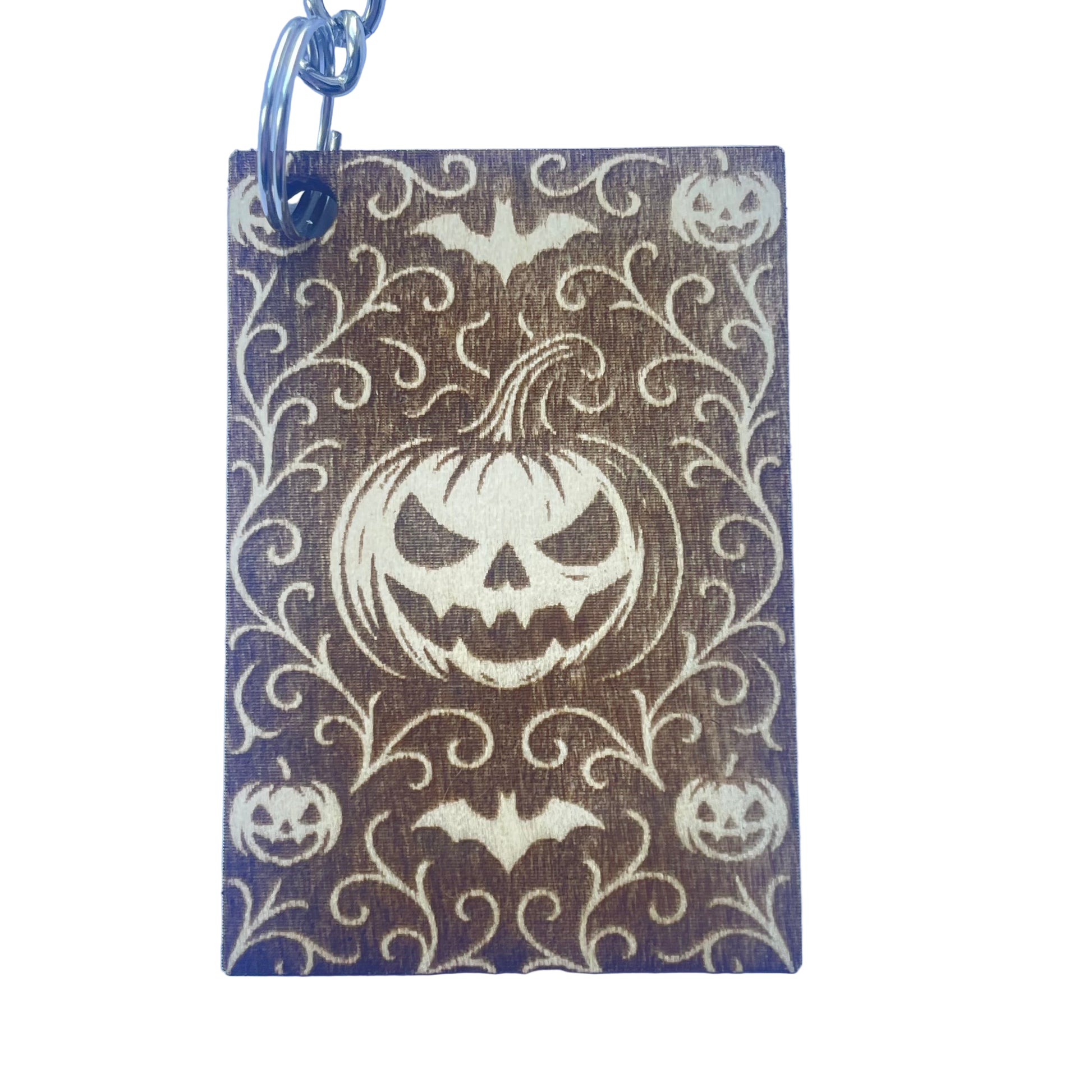 Keychain with Halloween design featuring pumpkins and bats on a brown background.