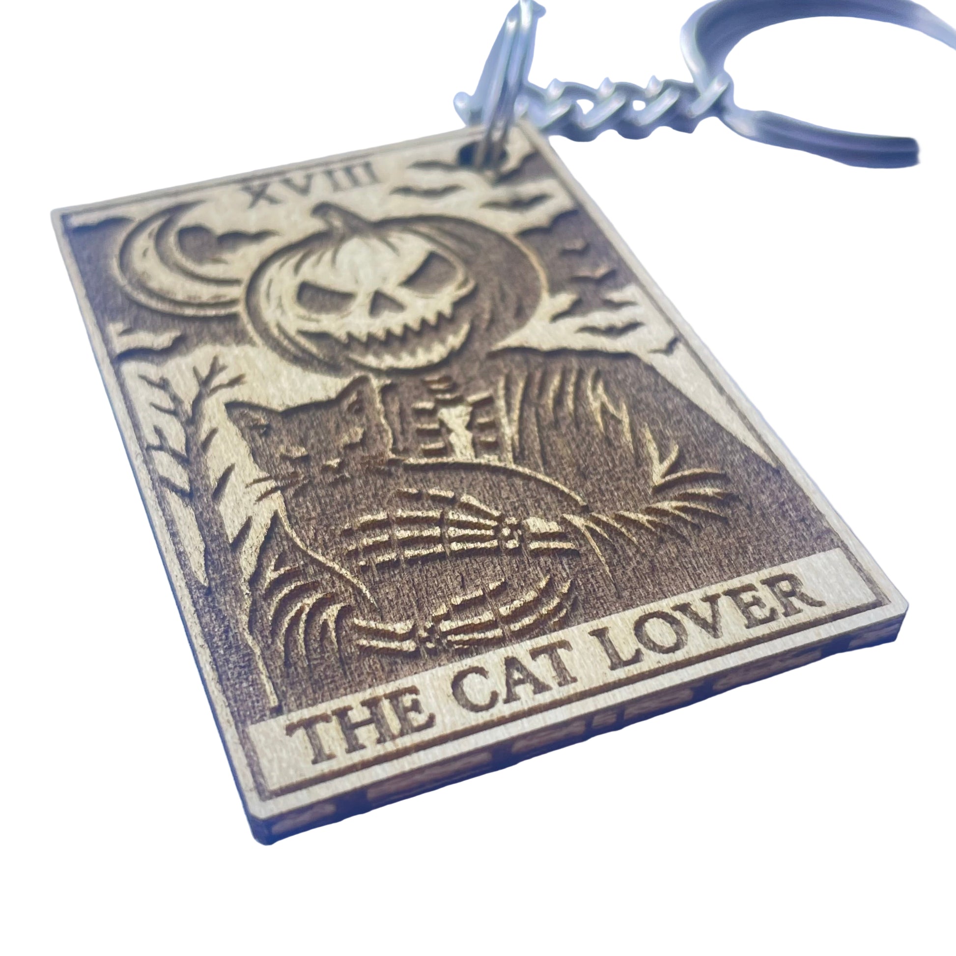 Keychain with a cat and pumpkin design and 'The Cat Lover' text on a light blue background