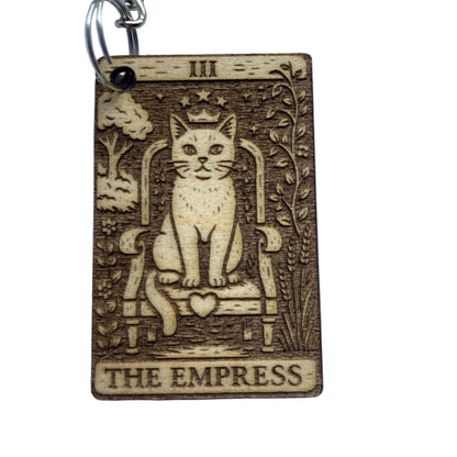 Keychain with a cat design inspired by 'The Empress' tarot card on a light blue background