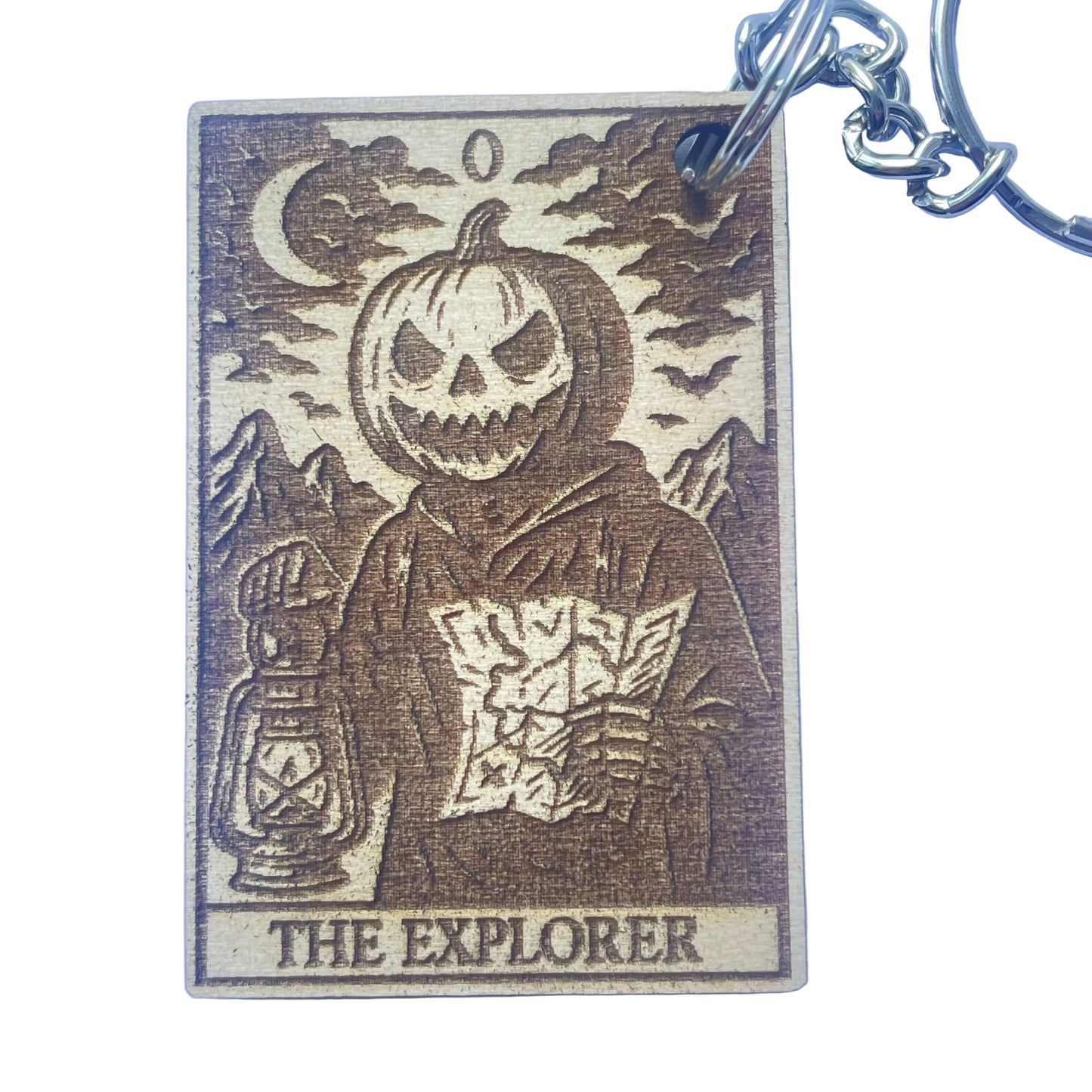 Keychain with a design of a character wearing a pumpkin head, holding a lantern, and the text 'The Explorer' on a blue background.