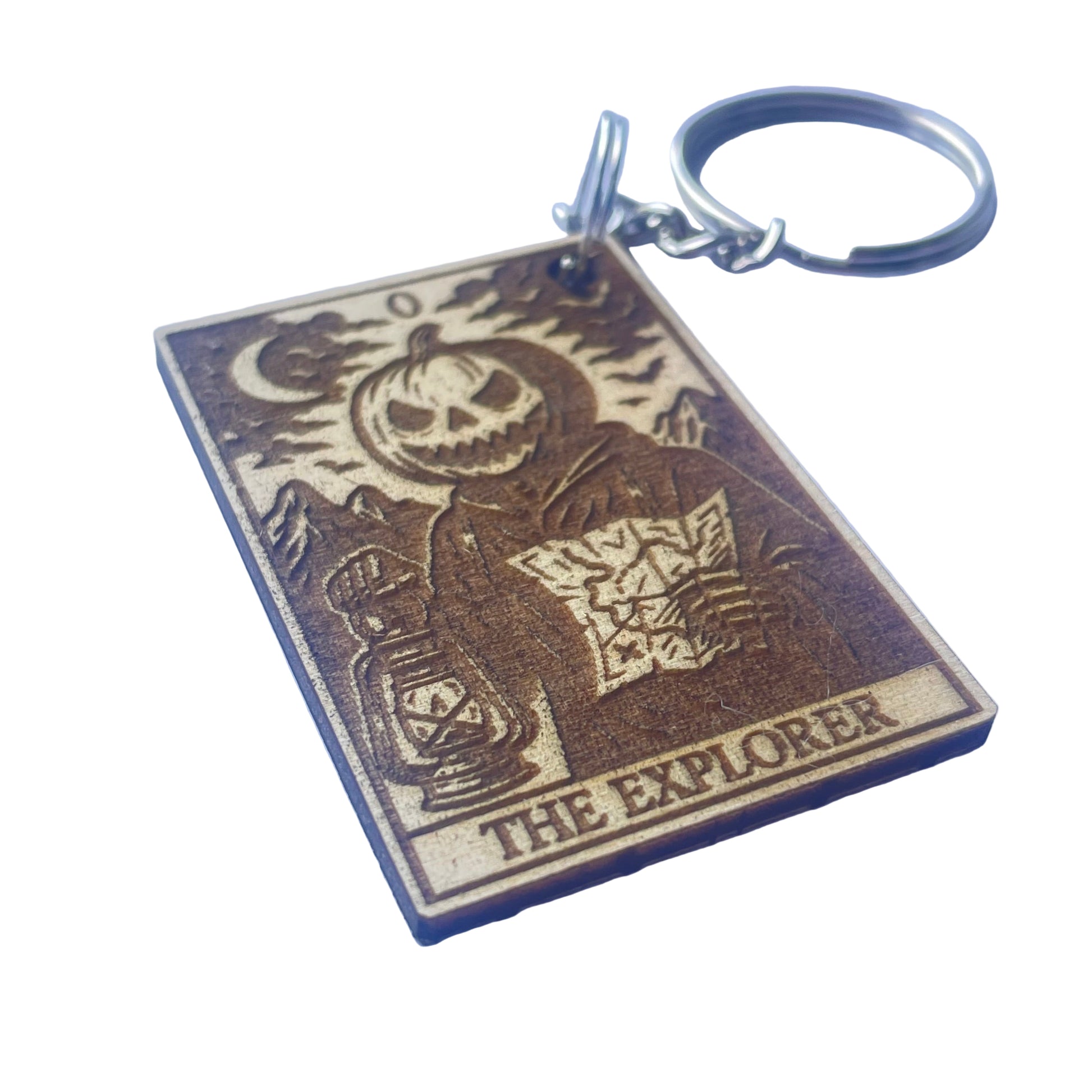 Keychain with a design of a skeleton holding a map and 'The Explorer' text on a purple background