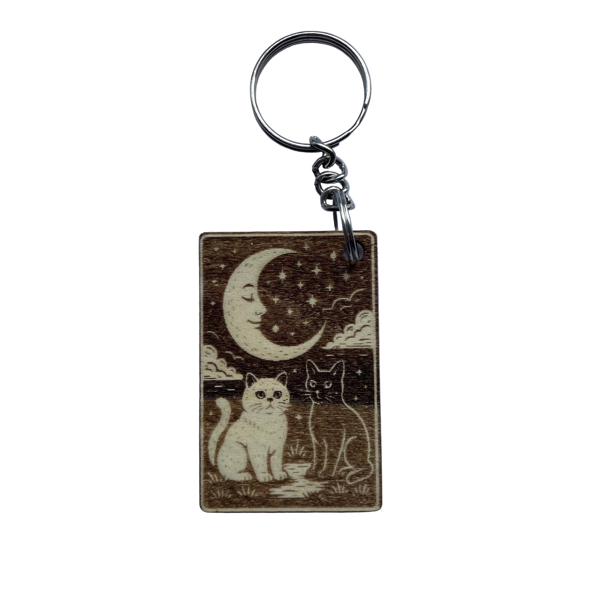 Keychain with cats under a moon and stars design on a light blue background