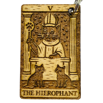 Wooden card with engraved design of a cat in a robe and the text 'The Hierophant' on a white background.