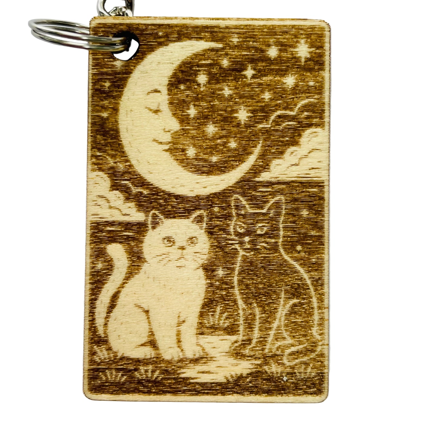 Wooden keychain with cats and a moon design on a white background