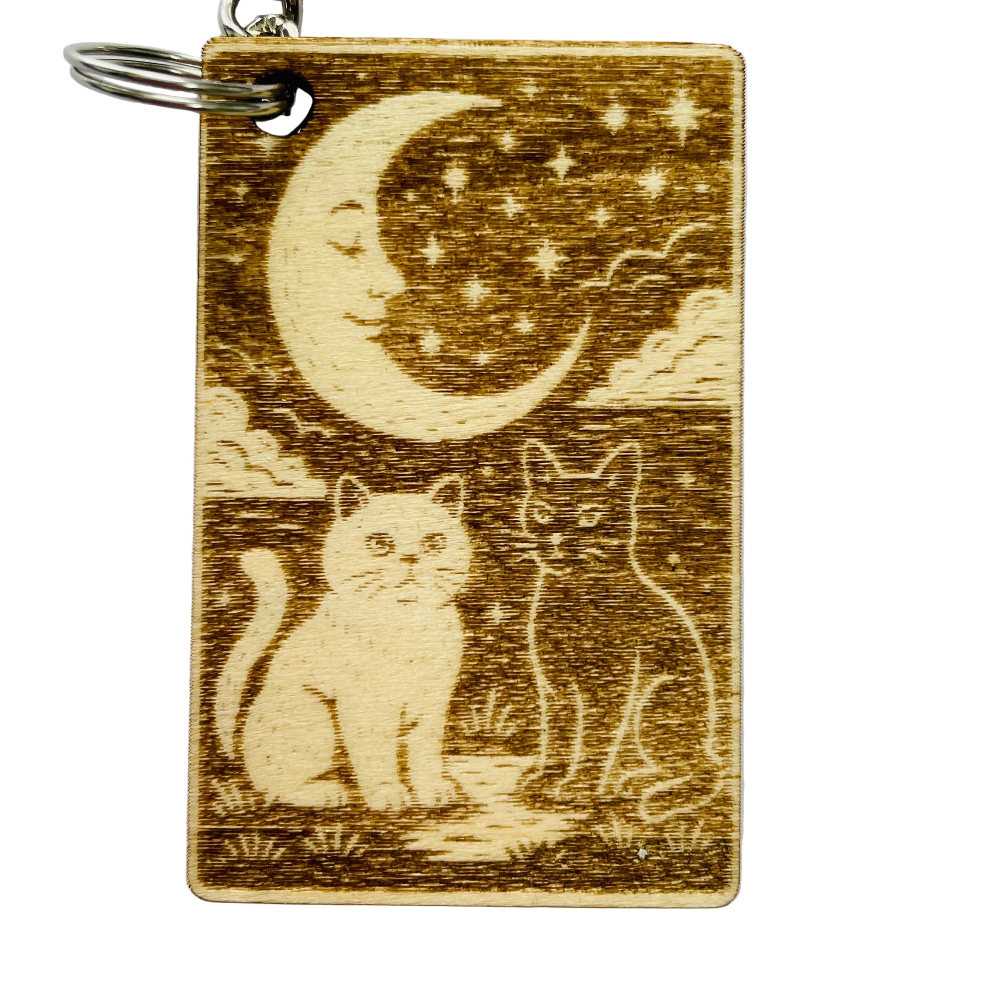 Wooden keychain with cats and a moon design on a white background