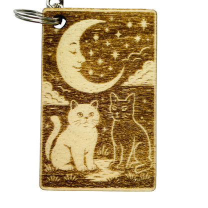 Wooden keychain with cats and a moon design on a white background