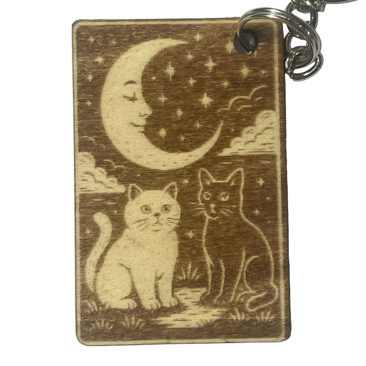 Wooden keychain with cats and a moon design on a white background