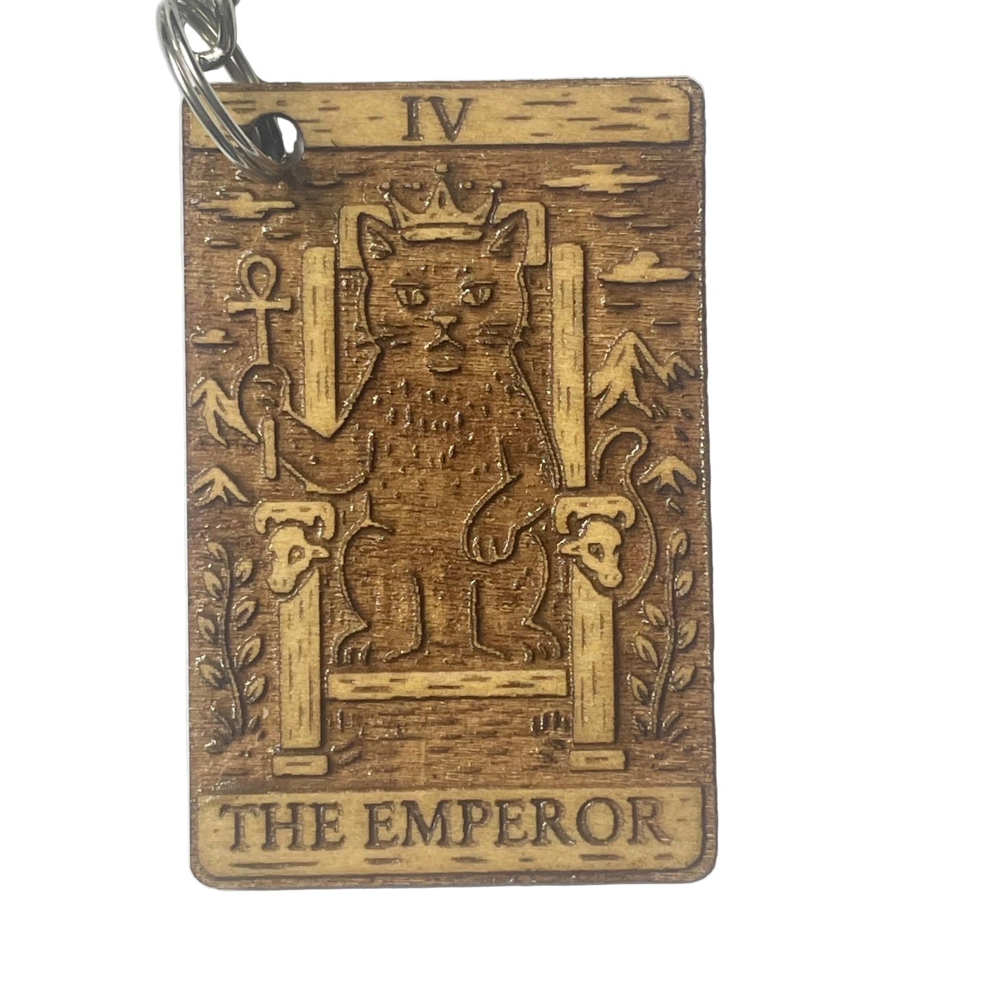 Wooden keychain with engraved design of 'The Emperor' from a tarot card on a white background