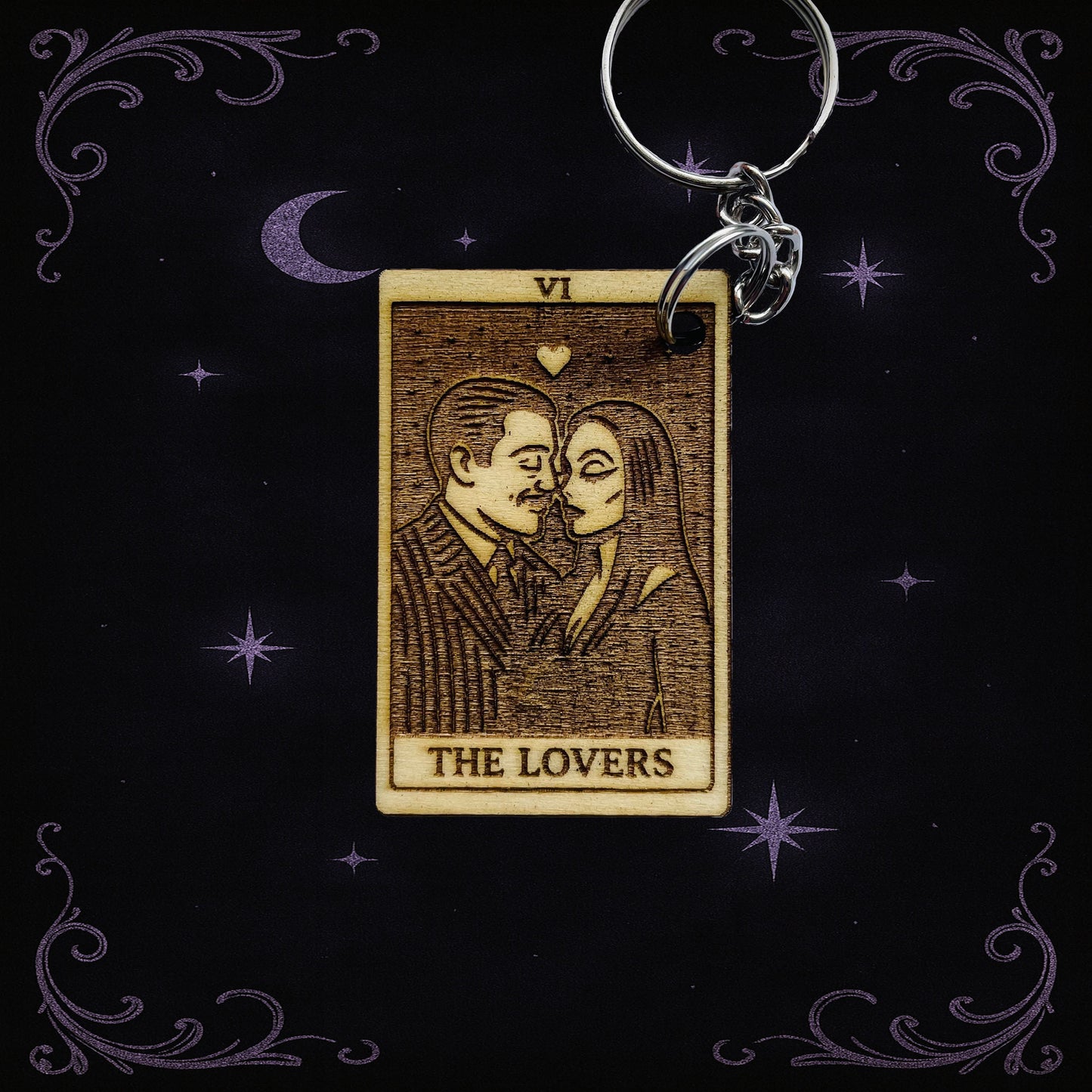 Keychain with 'The Lovers' tarot card design on a dark background