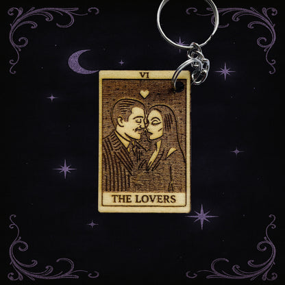 Keychain with 'The Lovers' tarot card design on a dark background