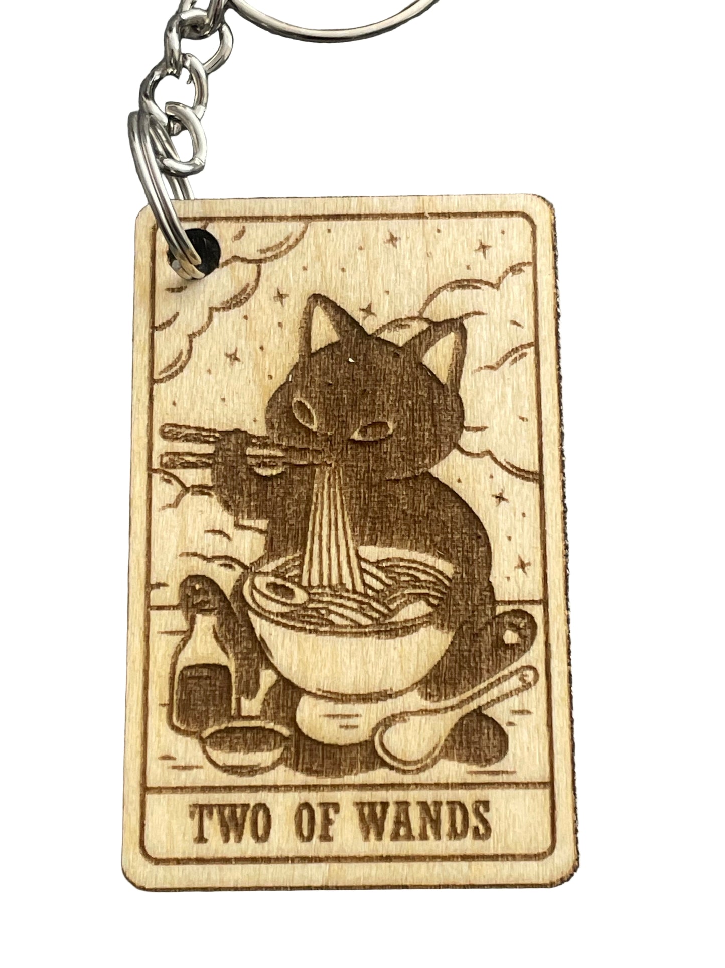 Wooden keychain with tarot card design featuring a cat and 'Two of Wands' text on a gray background.
